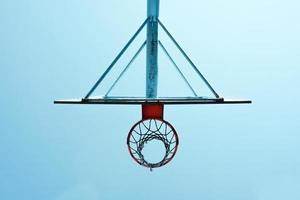 old abandoned street basketball hoop and blue sky background photo