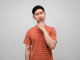 Asian man striped shirt orange color gesture thinking isolated photo