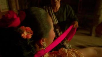 Javanese women celebrate the new year by dancing together in orange dresses and green scarf inside the traditional dance festival video