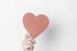 A photo of a red heart shape paper isolated on white background.