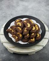 Choco cashew cookies. Chocolate cookies with cashew nut topping. photo