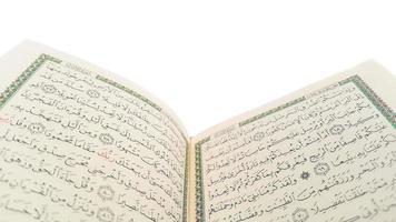 Open Quran pages with white background. Surah Al Baqarah. Arabic letters. Selective focus on letters. Al-Quran is a holy book of Islamic guidance isolated. Religion concept. photo