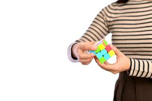 female hands holding a rubik cube standing on white background photo