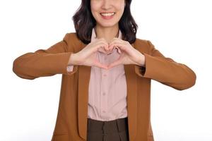 Young Asian woman showing hand heart sign isolated on white background, Spreading love and happiness concept photo