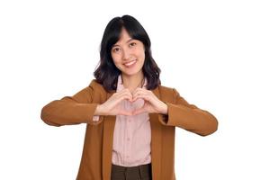 Young asian woman hands making a heart shape on a white isolated background photo