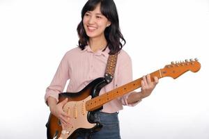 Asian woman playing a vintage sunburst electric guitar isolated on white background photo