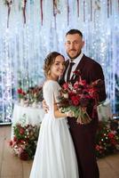 portrait of a young couple of newlyweds in wedding looks photo