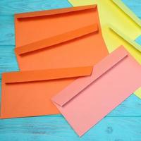 Group of colorful envelopes on wooden table, mock up photo