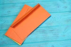 Group of colorful envelopes on wooden table, mock up photo