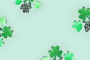 St. Patrick's Day balnk greeting card. Paper clover leaves on colored background with copy space photo