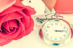 Close up pocket watch and red roses flower photo