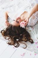 Close-up portrait of young beautiful model with rose photo