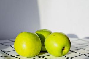 Green apples on the table. White tablecloth. Delicious breakfast. photo