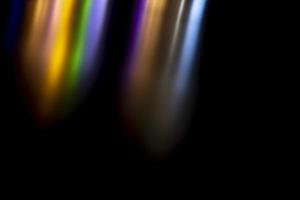 Abstract texture reflection of light. Colored background highlights in surface. Stripes of color turning to black. photo