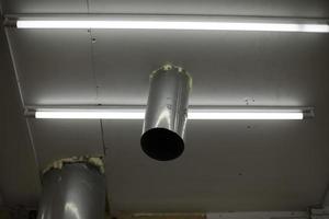 Pipe in ceiling. Pipe comes out of roof inside. Steel profile. photo