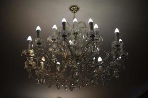 Chandelier on ceiling. Crystal chandelier in chamber. Expensive interior. photo