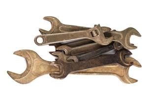 A lot of wrenches of different sizes lie in a pile on a white background. Wrenches isolated on white background. photo