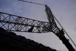 Silhouette Huge Crawler Crane with Sunset Background. photo