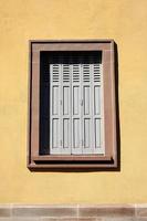 Vintage Wooden Window on Stucco Wall Background in Minimal Style. photo