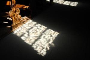 Vintage Wooden Bench in the Church with Light Beam Shining to to Floor. photo