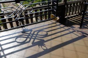 Fence Shadow on the Ground on Eiffel Tower. photo