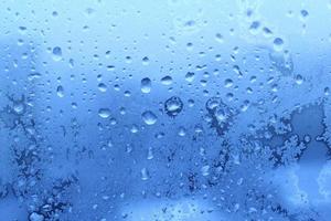 Ice and water drops on glass, close-up natural texture photo