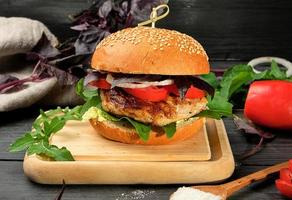 homemade hamburger with pork fried steak, red tomatoes photo