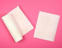 twisted roll of white soft paper napkins for face and hands photo