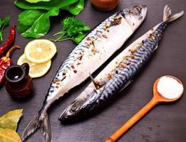 mackerel in spices on a black wooden background photo