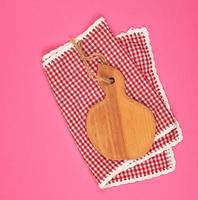 kitchen wooden cutting board and white red checkered kitchen towel photo