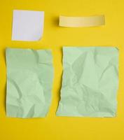 various torn pieces of paper on yellow background photo