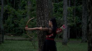 femmes asiatiques prêtes à tirer une flèche de l'arc tout en se tenant courageusement video