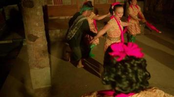 Javanese women celebrate the new year by dancing together in orange dresses and green scarf inside the traditional dance festival video