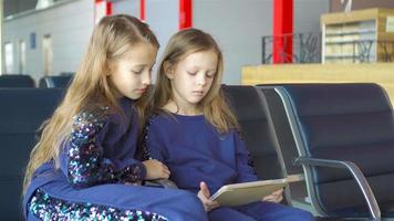 Little adorable girls in airport near big window video