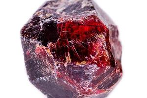 Macro of a mineral garnet stone on a white background photo