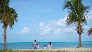 Family on the beach on caribbean vacation. video