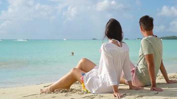 Young couple on white beach during summer vacation. video