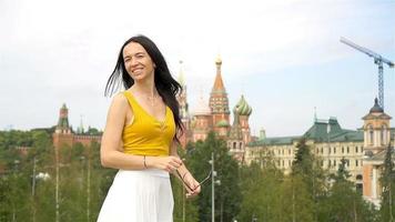 Happy young urban woman in european city. video