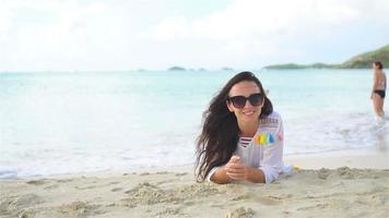 Young beautiful woman on beach during tropical vacation video