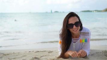 Young beautiful woman on beach during tropical vacation video