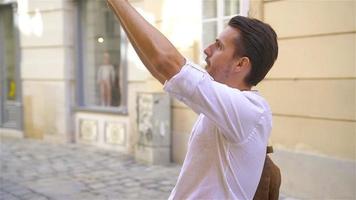 Young man background the old european city take selfie video