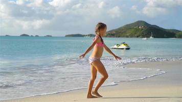 Sihouette of little girl dancing on the beach at sunset. video