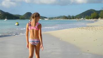 Active little girl at beach having a lot of fun. video