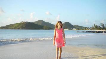 Active little girl at beach having a lot of fun. video