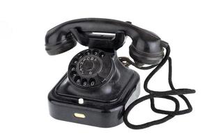 Old vintage black phone on white background photo