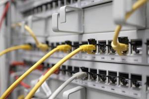 Network technology - multiple colorful cables in an IT and server room photo