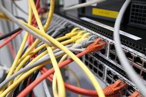 Network technology - multiple colorful cables in an IT and server room photo