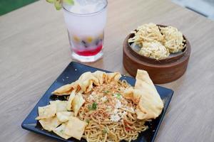 fried noodles with crackers and fresh fruit drinks photo