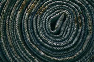 Close up Old Fire Hose Texture Background in Dark Tone, Suitable for Safety Concept. photo