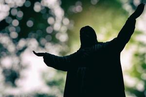 Jesus Silhouette with Beautiful Bokeh Background, Suitable for Christian Religion Concept. photo